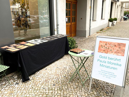 Miniaturbilder mit Gold, Silber und Kupfer vor dem Regen vor der Galerie